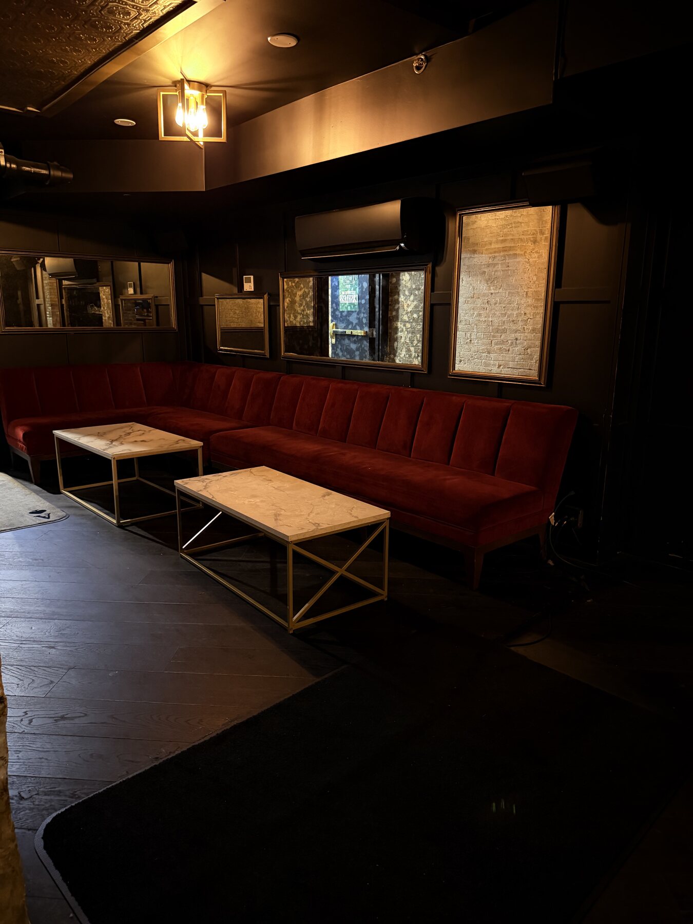 Deep red lounge seating and marble cocktail tables